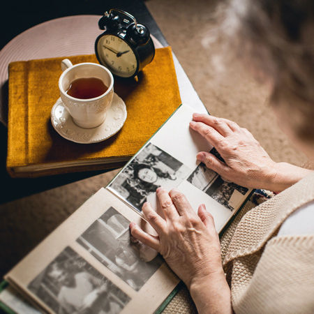 A photo album of black and white pictures of people.